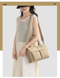 Detailed view of the casual canvas shoulder bag with dual exterior pockets and adjustable straps.