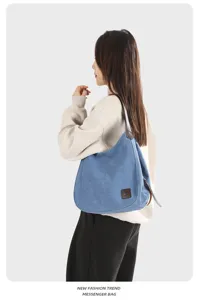 Casual blue canvas shoulder bag showcasing detailed side view and textured fabric design.