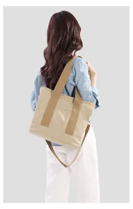 Back view detail of casual khaki canvas shoulder tote bag for daily wear style.