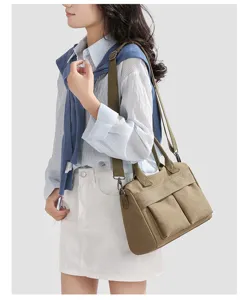 Canvas shoulder crossbody bag detail view, casual large capacity daily commuting tote style.