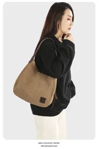 Retro brown canvas shoulder bag worn by model, showing casual daily fashion style and details.