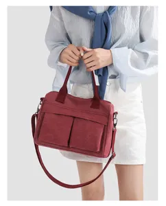 Detailed close-up view of the casual canvas shoulder handbag featuring dual pockets