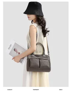 Canvas crossbody bag detail view, casual shoulder handbag with dual front pockets.