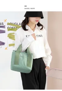 Casual green canvas tote bag for women, stylish large capacity handbag for daily commute.