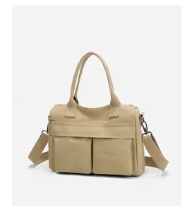 Canvas tote bag detail view showing durable fabric, double handles, and front pocket design.