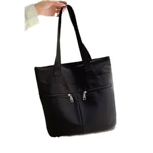 Black nylon tote bag for women, large capacity minimalist shoulder handbag with zipper pockets.