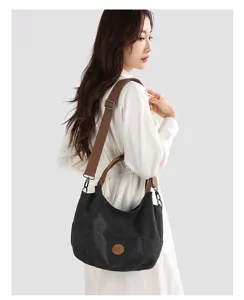 Detailed shot of a casual canvas shoulder bag with brown straps, stylish daily commute tote.