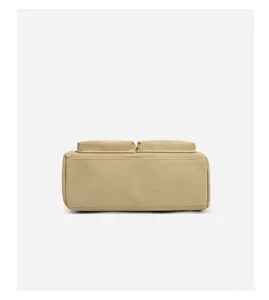 Close-up detail of casual khaki canvas handbag bottom structure, minimalist daily design.