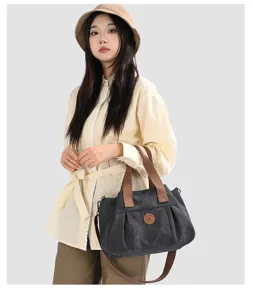 Stylish large capacity canvas crossbody bag for women, versatile everyday shoulder handbag.