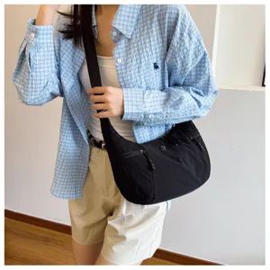Casual black nylon crossbody bag detail, lightweight daily shoulder travel bag style.