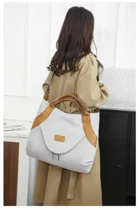 Large capacity nylon tote bag with brown leather trim, stylish daily shoulder bag for women.