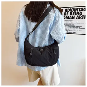 Casual black nylon crossbody hobo bag for women, lightweight crescent shoulder bag for daily travel.