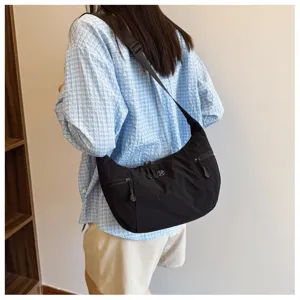 Casual nylon shoulder bag for women, lightweight crescent crossbody bag with zipper pockets.