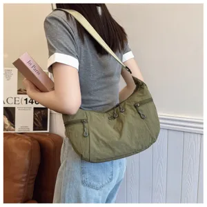 Detail view of casual green nylon shoulder bag, lightweight cross-body design for daily use.