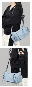 Close-up details of the vintage blue multi-pocket motorcycle shoulder bag showcasing pockets.