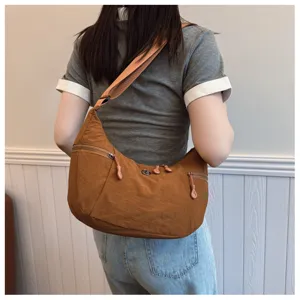 Casual nylon shoulder bag for women, lightweight crossbody dumpling bag for daily use.