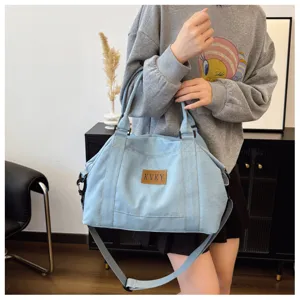 Borsa a tracolla in denim casual di grande capacità con doppi manici e cinghia regolabile.