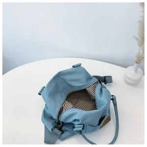 Borsa a tracolla in tela blu, grande borsa da viaggio casual con fodera a righe interne.
