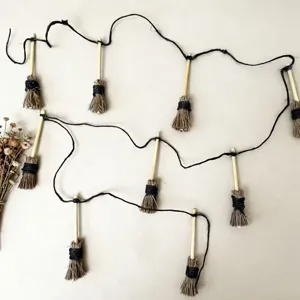 Halloween miniature straw broom hanging ornament detail showing natural rustic craft style.