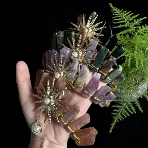 Close-up detail of handmade natural crystal crown hair comb with sun goddess metal charms and pearl.