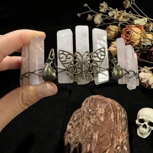 Gothic crystal crown headband with raw pink quartz, metal butterfly and skull details for photo.