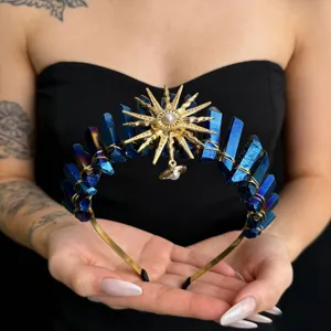 Detail view of blue crystal crown headband featuring sun goddess charm and pearl accents.