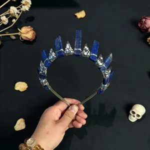Close-up detail of gothic crystal crown headband with natural blue stones and metal skull accents.