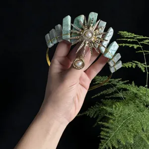 Detailed view of handmade crystal crown headband with sun goddess charm for photography.