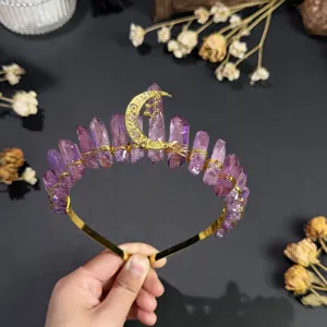 Close-up detail of natural purple crystal crown headband with golden star and moon decor.
