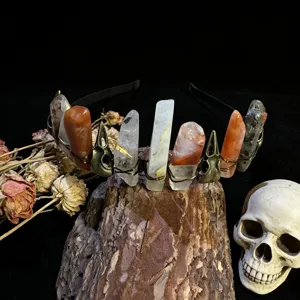 Close-up detail of gothic crystal crown headband with raw stones and metal raven skull charms.