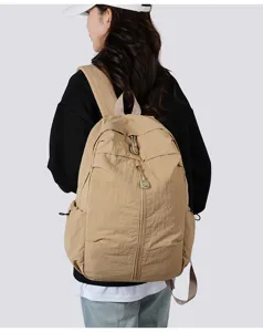 Lightweight casual backpack for daily travel and school, durable fabric with pockets.