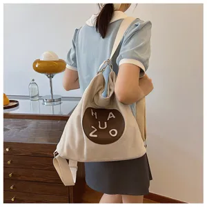 Sac à bandoulière en toile décontracté pour femme, sac à dos élégant avec patch rond.