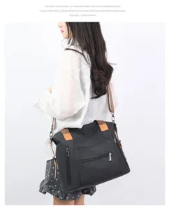 Minimalist black canvas shoulder bag for women, large capacity tote bag with brown straps.