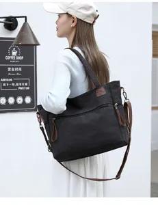 Classic black canvas tote bag with brown straps, large capacity shoulder crossbody travel bag.