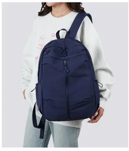 Lightweight dark blue casual backpack detail, featuring durable zippers and comfortable straps.