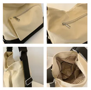 Detail view of a casual canvas shoulder bag with black bottom, zipper pocket, and striped lining.