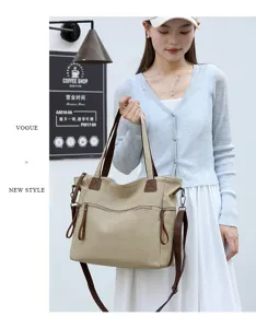 Canvas tote bag with brown straps, large capacity shoulder and crossbody travel bag.