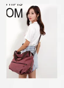 Detail view of the casual canvas shoulder bag in maroon, showcasing spacious design and straps.