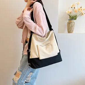Canvas shoulder bag for women, trendy minimalist crossbody bag featuring front pocket and contrast.