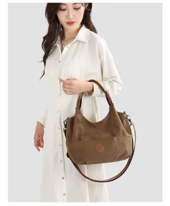 Canvas shoulder bag detail shot showing brown tote design, durable fabric, and comfortable strap.