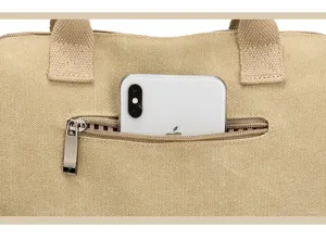 Close-up detail of khaki canvas handbag front zipper pocket showing convenient storage capacity.