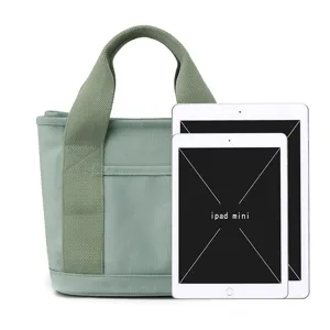 Casual green canvas tote bag for women, large capacity handbag with sturdy webbing handles.