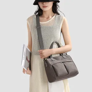 Casual canvas handbag for women, large capacity shoulder and crossbody bag with front pockets.