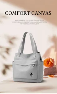 Detailed view of grey canvas tote bag with front pocket and leaf logo, elegant minimalist style.