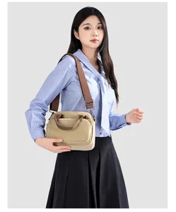 Detail view of casual canvas crossbody bag worn by model showcasing everyday fashion style.