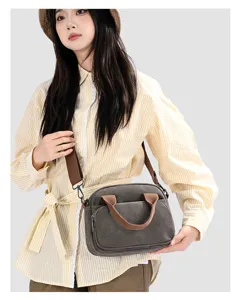 Korean style casual canvas crossbody bag for women with contrast color handles and adjustable strap.