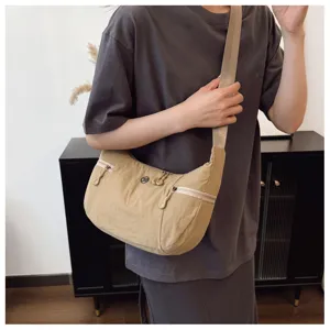 Casual nylon crossbody bag for women, lightweight crescent shoulder bag for daily commute use.