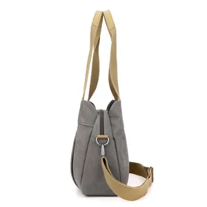 Grey canvas shoulder bag side view, casual tote bag with khaki straps for daily use.
