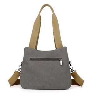 Stylish grey canvas shoulder bag with durable khaki straps and zipper pocket daily use.