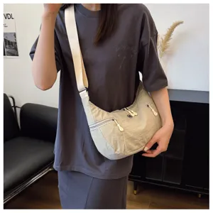 Casual nylon crossbody bag for women, lightweight crescent shoulder bag with wide strap.